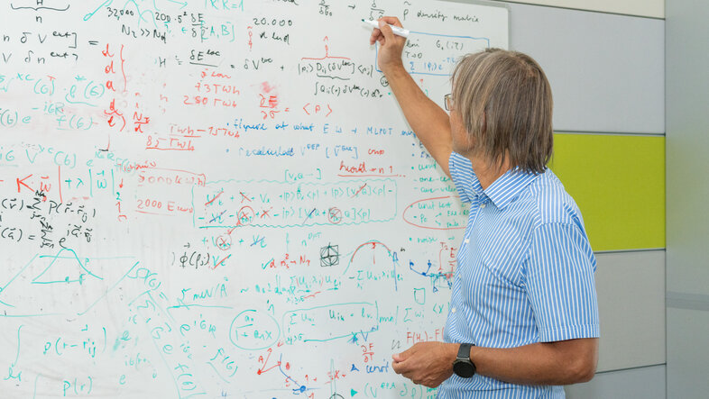 Prof. Georg Kresse scribbling on a whiteboard
