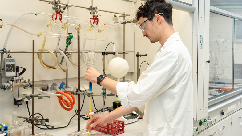 A scientist at a chemical fume hood