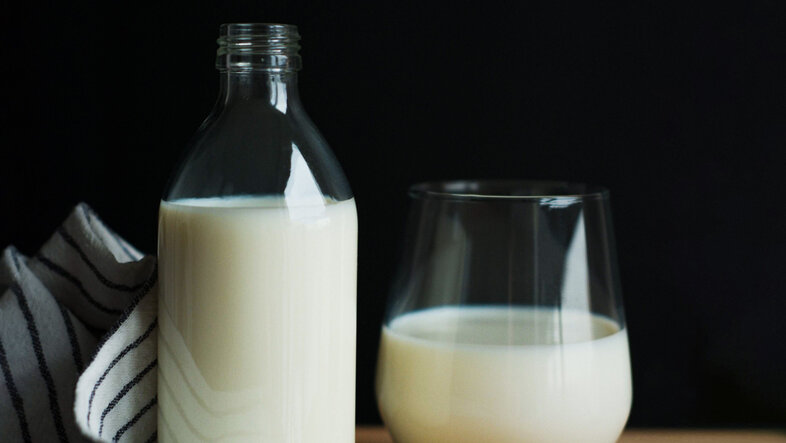 A bottle and a glass of milk