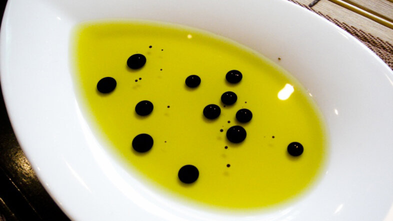 Drops of vinegar in olive oil