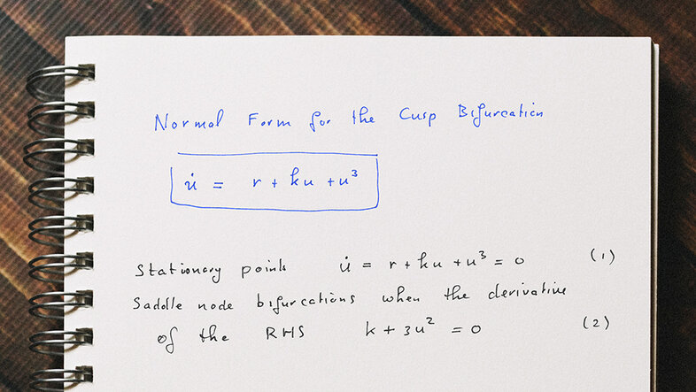 Hand-written notes on a pad: "Normal Form for the Cusp Bifurcation. du/dt = r + ku + u^3. Stationary points du/dt = r + ku + u^3 = 0 (1). Saddle node bifurcations when the derivative of the RHS k + 3u^2 = 0. (2)"