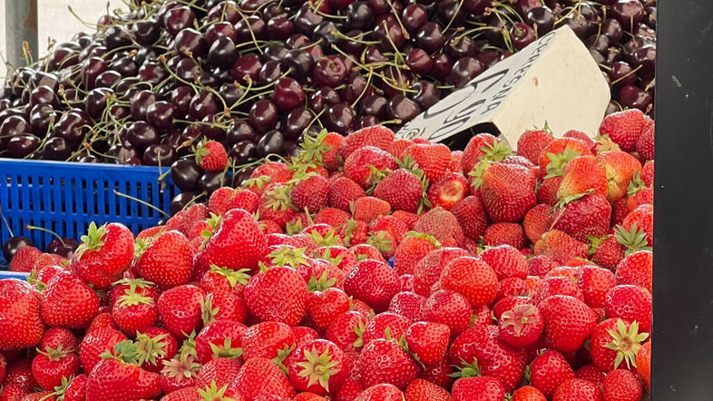 Market stall with strawberries and cherries