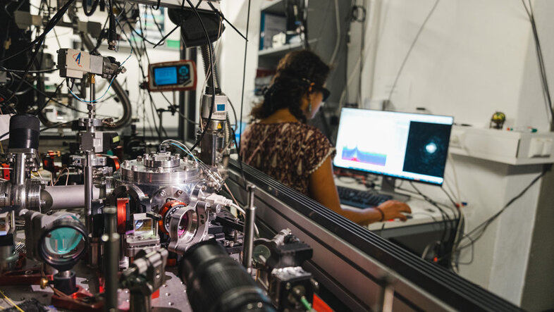 Photo from the quantum laboratory with optical apparatus. Mirrors, lasers, lenses, computer.